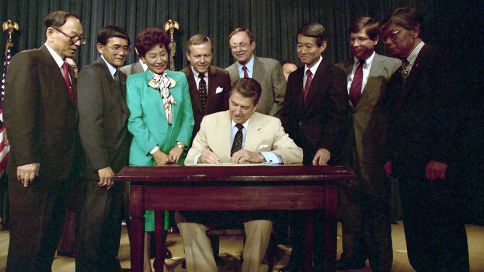 President Reagan signing a reparations bill in 1987 for Japanese-Americans interned during World War Two