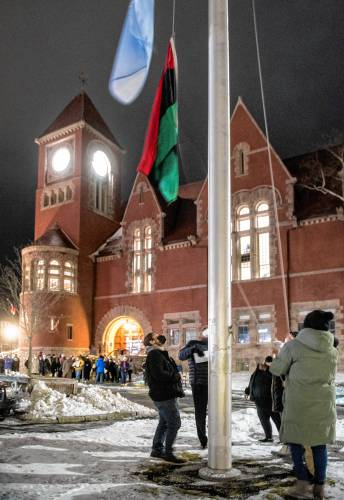 The red, black and green Pan-African flag is raised in front of Amherst Town Hall on Tuesday, Feb. 1, 2022, along with the United Nations flag, to begin the town's celebration of Black History Month.