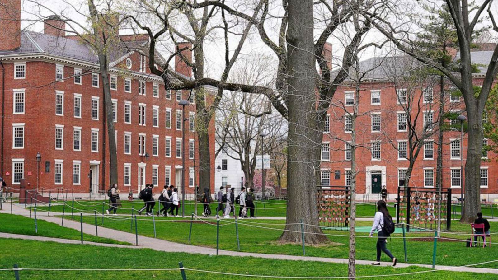 Students walk through Harvard Yard on the campus of Harvard University in Cambridge, Mass., April 27, 2022. 