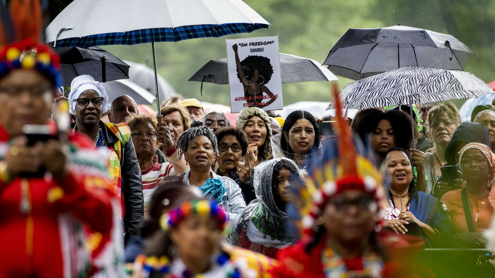 Spectators listen to Dutch King Willem-Alexander who apologized for the royal house’s role in slavery and asked forgiveness in a speech greeted by cheers and whoops at an event to commemorate the anniversary of the country abolishing slavery in Amsterdam, Netherlands, Saturday, July 1, 2023.