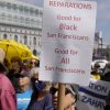 People listen during a rally in support of reparations for African Americans outside City Hall in San Francisco, Tuesday, Sept. 19, 2023.