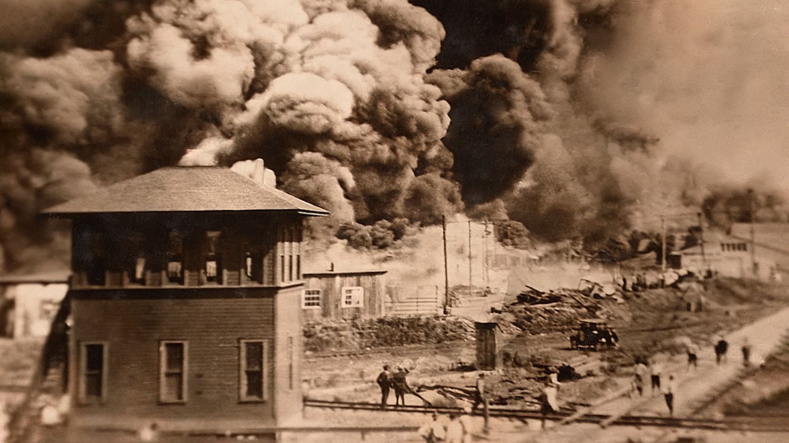 Buildings burn during the Tulsa Race Massacre in the Greenwood District in June 1921. 