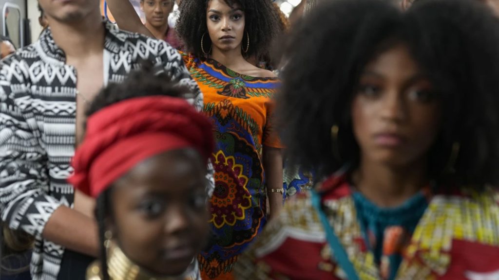 Models wear outfits designed by students from Afro-Brazilian communities at a subway station as part of Black Consciousness Awareness Month, in Sao Paulo, Brazil, Nov. 19, 2021.